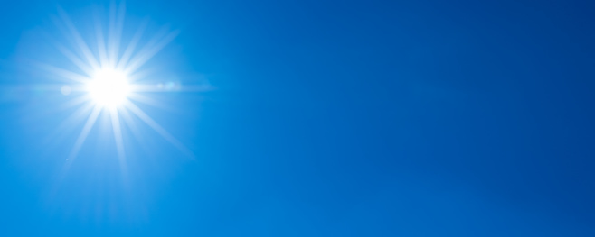 Sun, sunbeams against a blue sky - cloudless sky